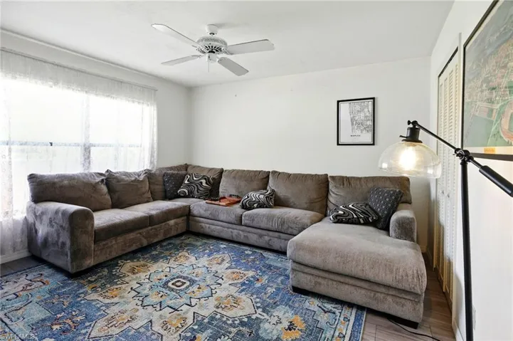 Living area featuring a ceiling fan and wood finished floors