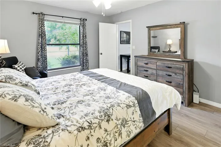 Bedroom featuring light wood-style flooring and baseboards