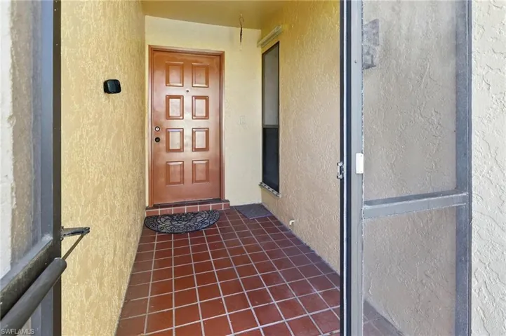 View of exterior entry with stucco siding