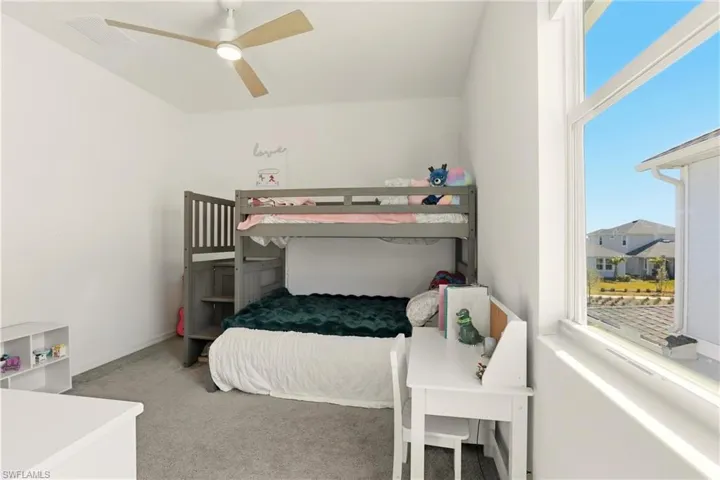 Bedroom with light colored carpet and ceiling fan