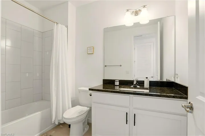Bathroom featuring shower / tub combo and vanity