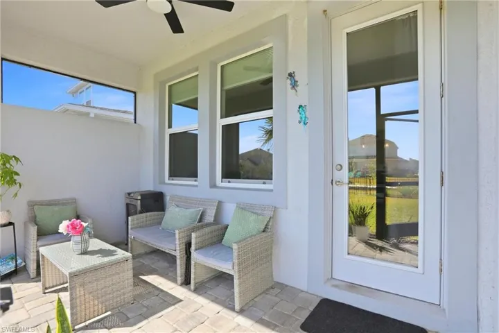 View of patio with a ceiling fan and an outdoor hangout area