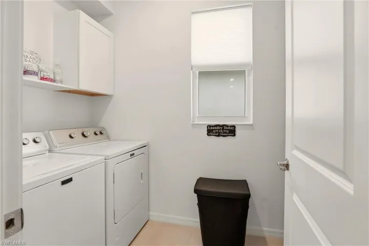 Laundry room with independent washer and dryer and cabinet space