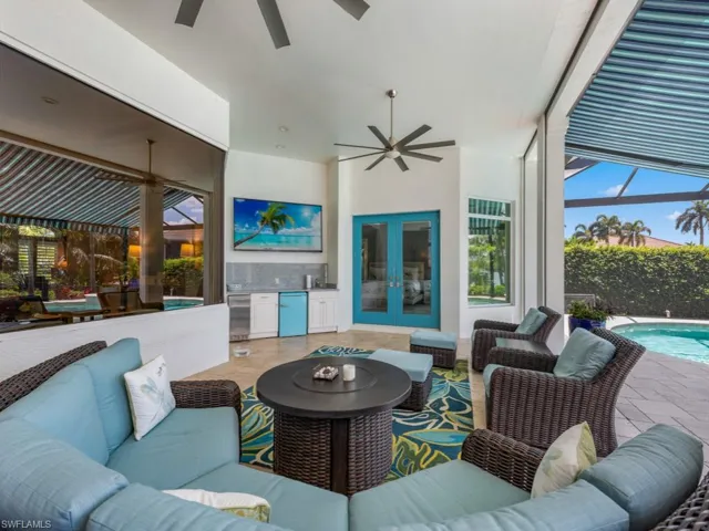 View of patio with an outdoor living space with a fire pit, french doors, and ceiling fan