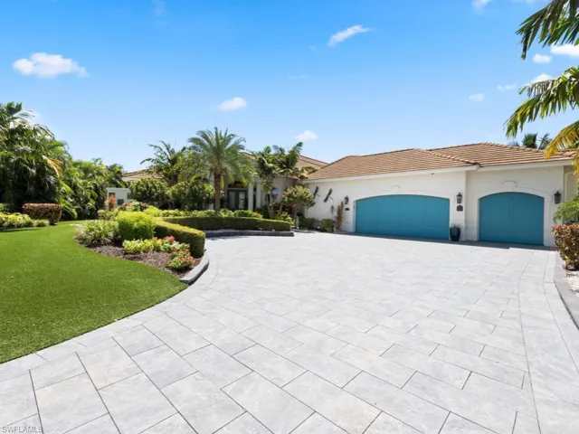 Mediterranean / spanish-style home featuring a garage and a front lawn