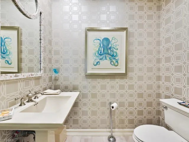 Bathroom with sink, tile walls, and toilet