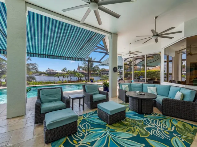 View of patio with an outdoor living space and ceiling fan
