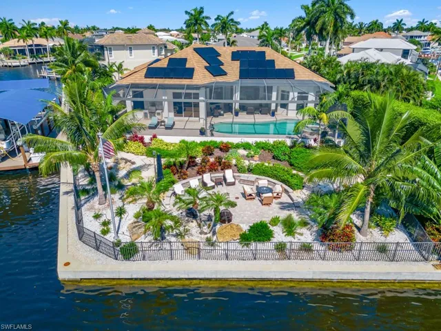 Back of house featuring a water view and a patio