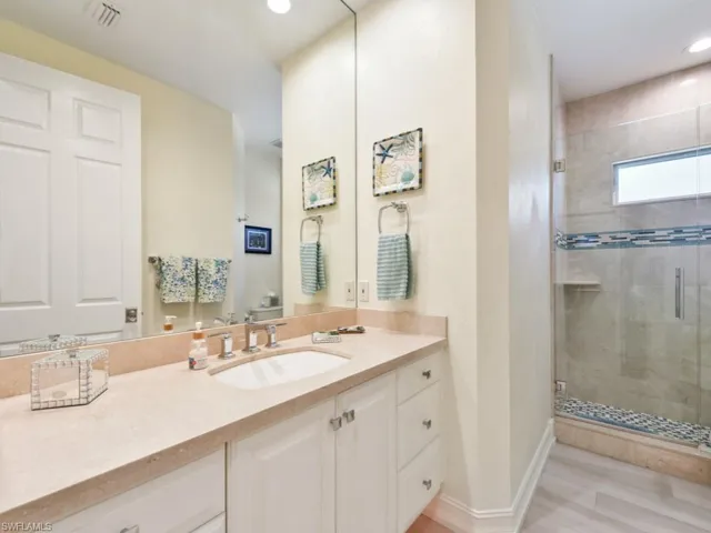 Bathroom featuring vanity and an enclosed shower