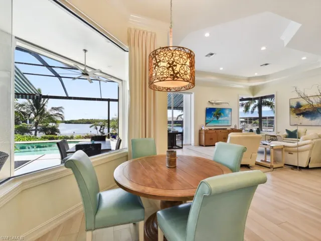 Dining space with ceiling fan and light hardwood / wood-style flooring