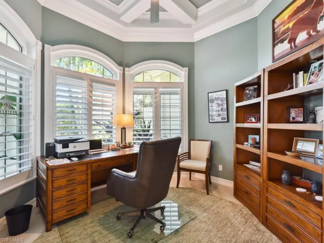 Home office featuring crown molding, wood-type flooring, and coffered ceiling