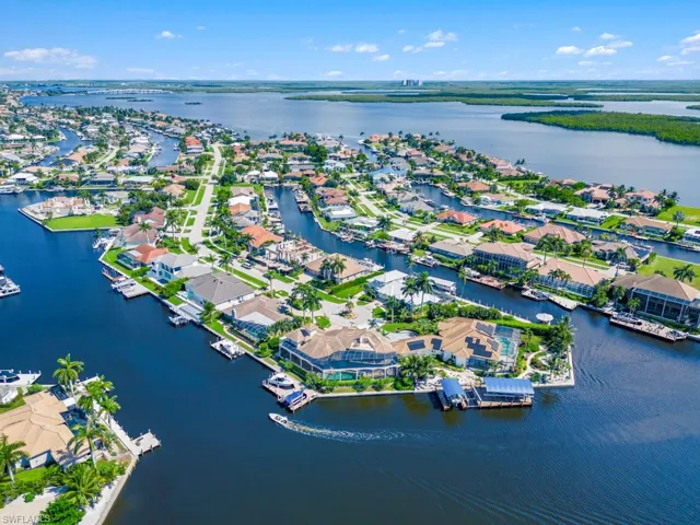 Birds eye view of property with a water view