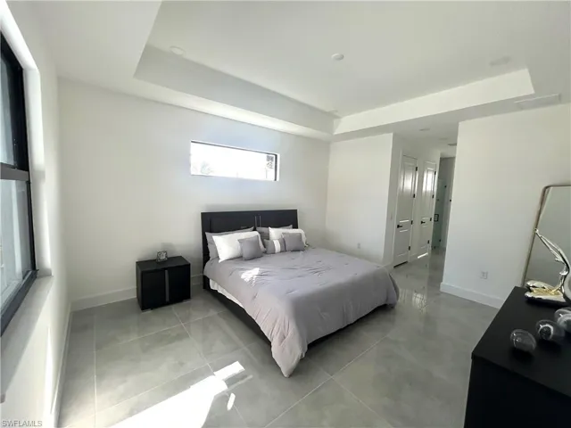 Bedroom with a raised ceiling