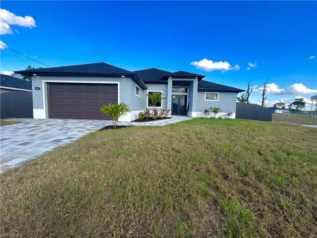 View of front facade with a front yard and a garage