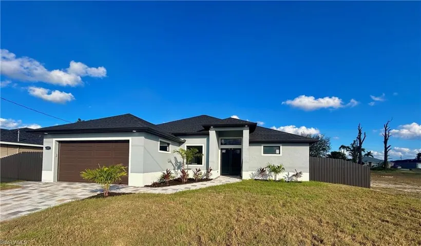 Prairie-style home featuring a garage and a front yard