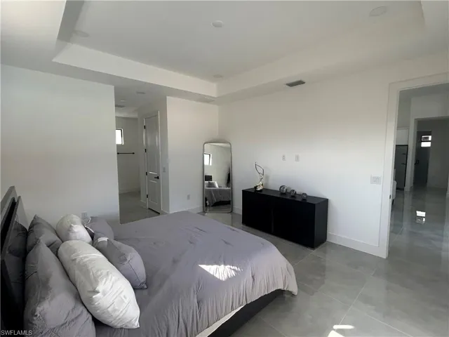 Bedroom with a raised ceiling