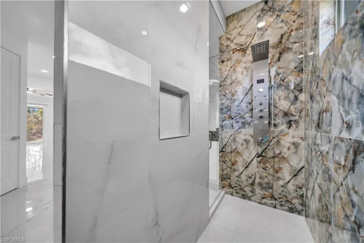Bathroom with a marble finish shower