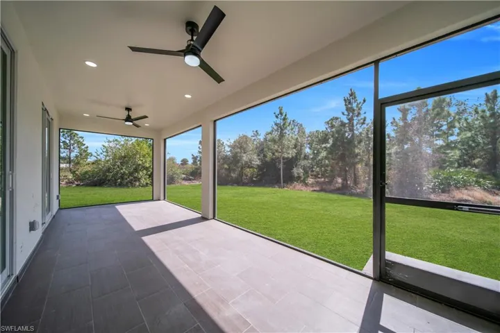 Unfurnished sunroom featuring a ceiling fan