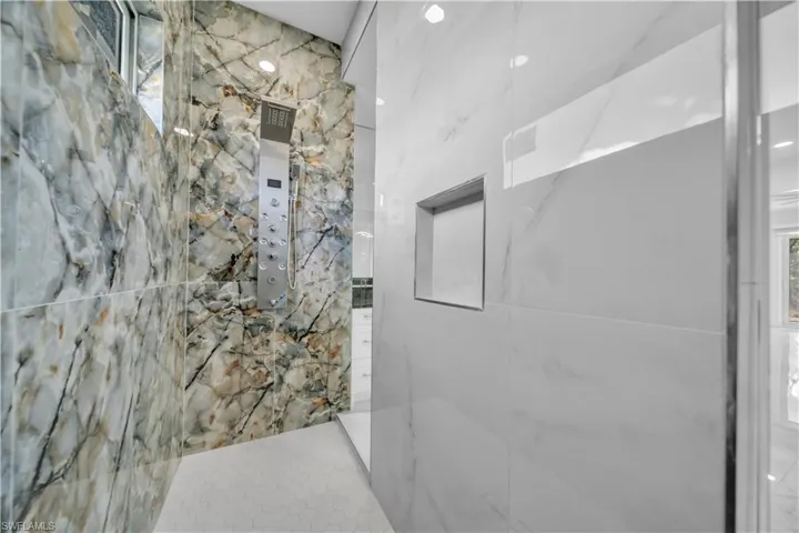 Bathroom featuring a marble finish shower