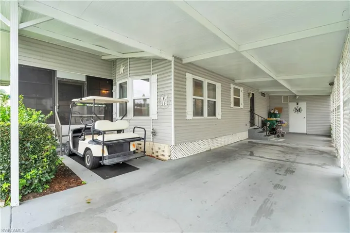 View of property exterior featuring a carport