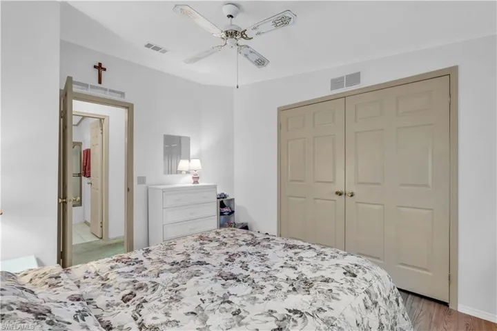 Bedroom with a closet, light wood-type flooring, and ceiling fan