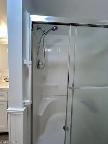 Full bath with vanity and a stall shower