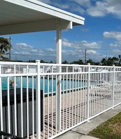 Community pool featuring a balcony and a patio area