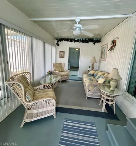 Sunroom / solarium featuring a ceiling fan and an outdoor hangout area