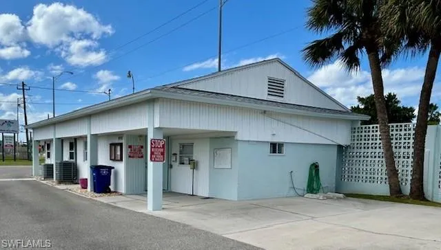 View of side of home featuring a carport and concrete driveway