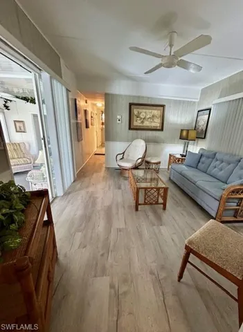 Living area featuring ceiling fan and light wood-type flooring
