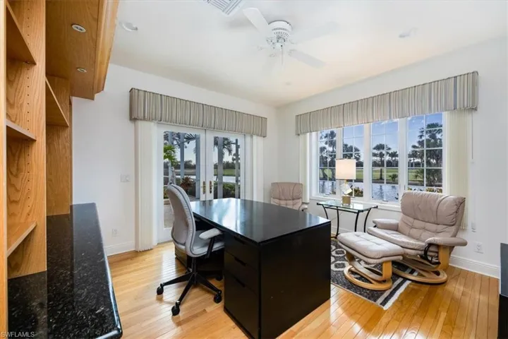 Home office featuring french doors, light hardwood / wood-style flooring, a wealth of natural light, and ceiling fan