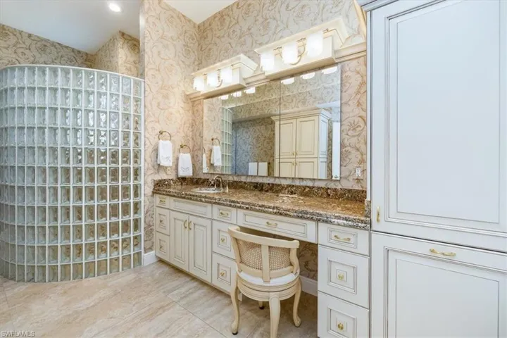 Bathroom with vanity and a shower