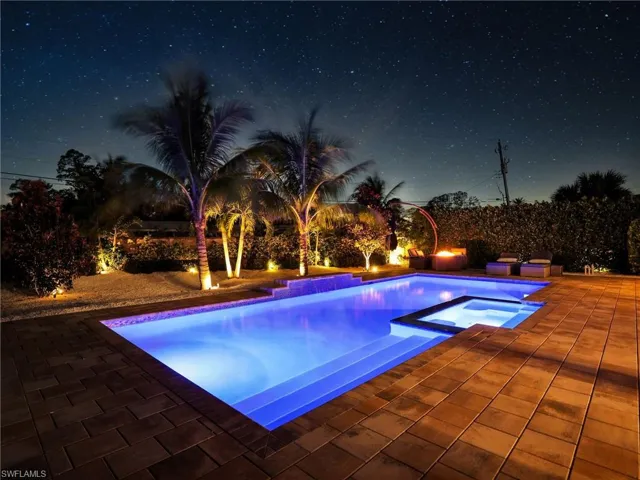 View of pool with an in ground hot tub and a patio