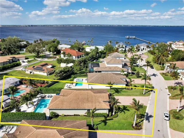 Birds eye view of property with a water view