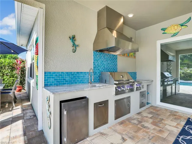 View of patio / terrace featuring area for grilling, exterior kitchen, and sink