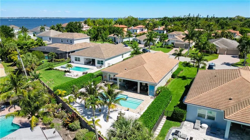 Birds eye view of property with a water view