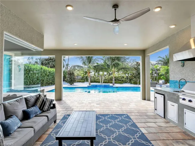 View of patio / terrace featuring outdoor lounge area, ceiling fan, and an outdoor kitchen