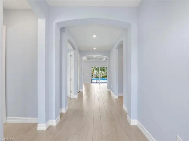 Corridor featuring light wood-type flooring