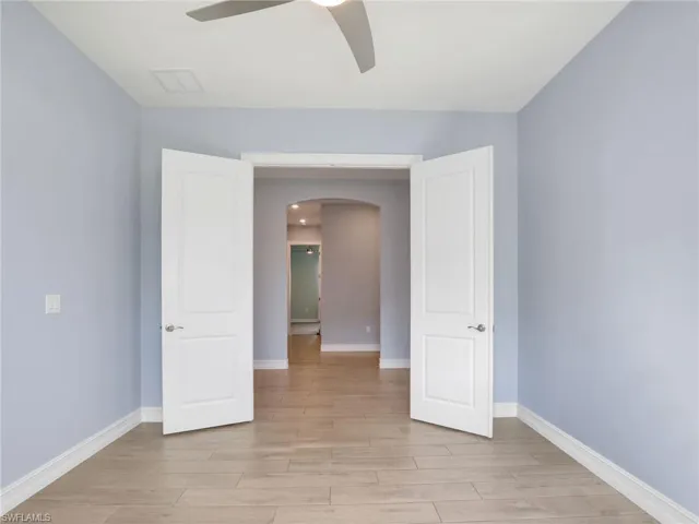 Empty room featuring ceiling fan and light hardwood / wood-style flooring