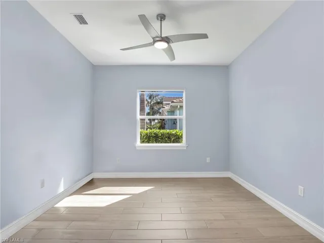 Spare room with light wood-type flooring and ceiling fan