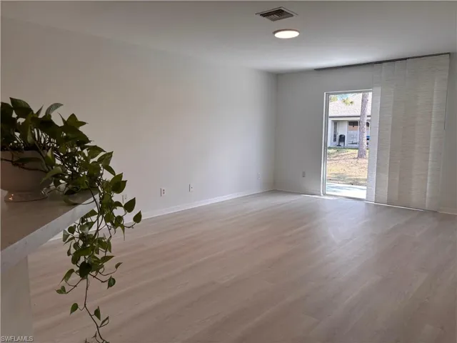 Unfurnished bedroom with light wood-style floors and two closets