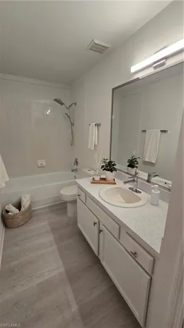 236 Full bath featuring vanity, bathtub / shower combination, and light wood finished floors