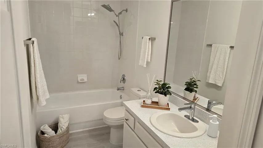 236 Bathroom with vanity,  shower combination, and light wood-type flooring
