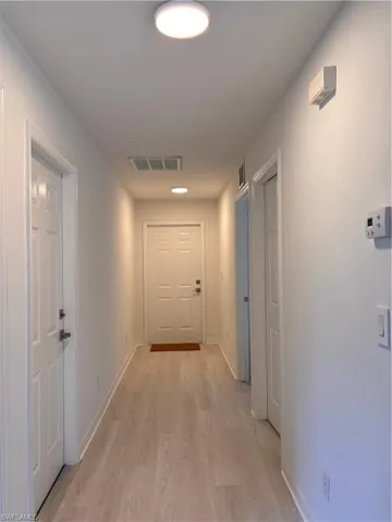 Unfurnished room with light wood-style floors and baseboards