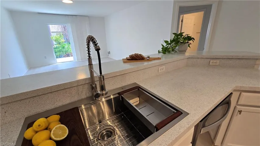 Corridor with light wood-style flooring and baseboards