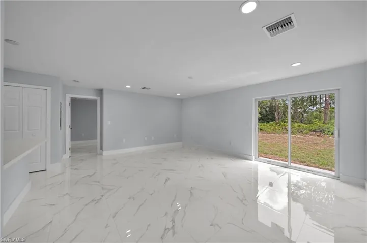 Unfurnished room with baseboards, marble finish floor, recessed lighting, and visible vents