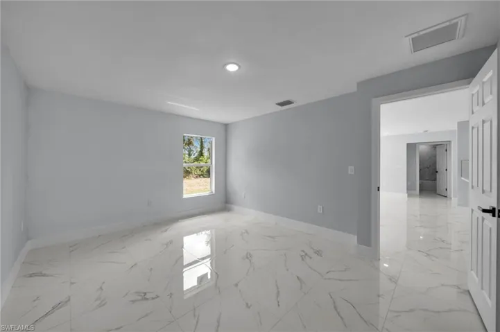 Unfurnished room featuring recessed lighting, baseboards, visible vents, and marble finish floor