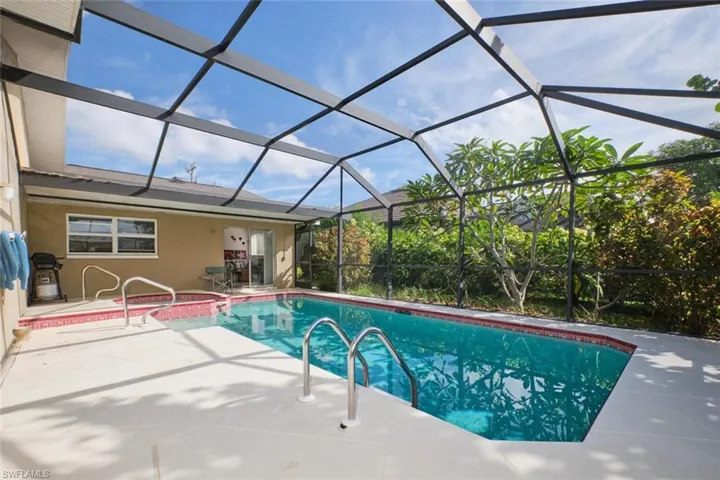 View of swimming pool with a lanai and a patio area
