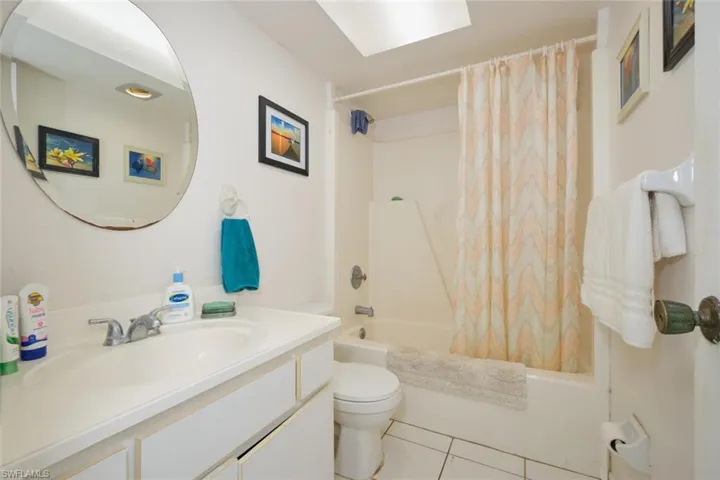 Apartment - Full bathroom featuring vanity, tile patterned flooring, toilet, and shower / bathtub combo