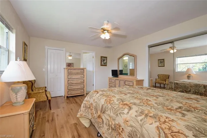 House - Primary Bedroom with ceiling fan and wood-style flooring